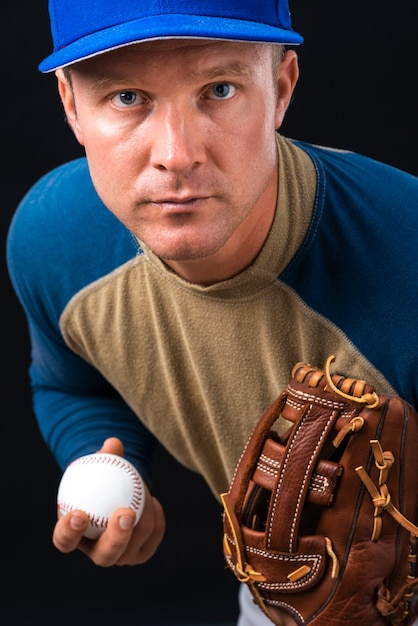 Free photo portrait of baseball player holding ball and glove