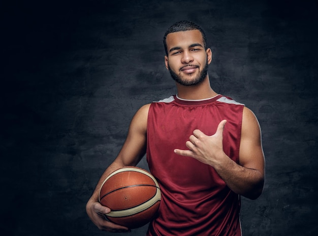 Portrait of a bearded black man holds a basket ball.