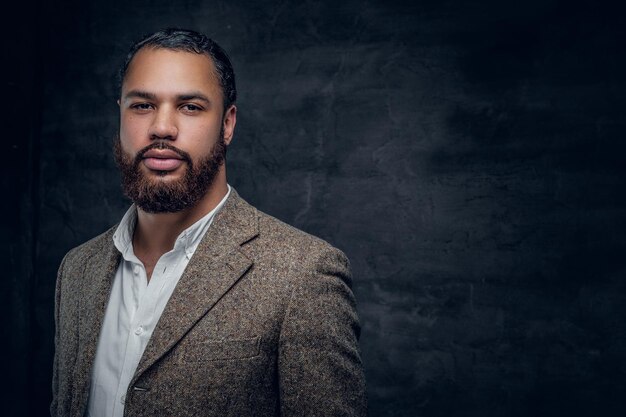 Portrait of bearded black man in a wool suit.