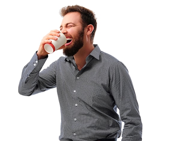 Portrait of bearded hipster male holds hot paper coffee glass isolatred on white background.