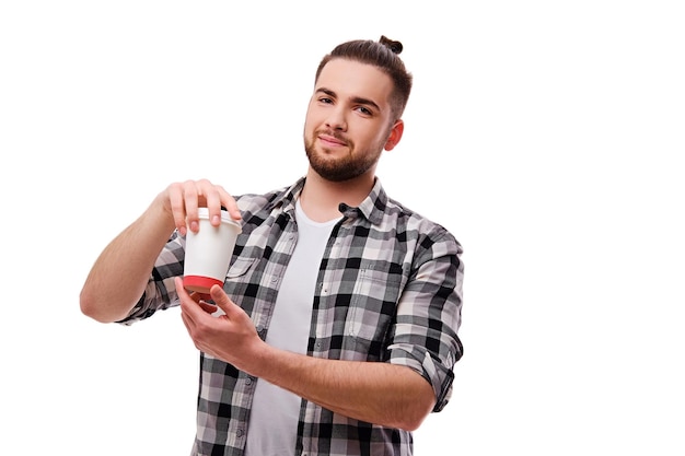 Portrait of bearded hipster male holds hot paper coffee glass isolatred on white background.