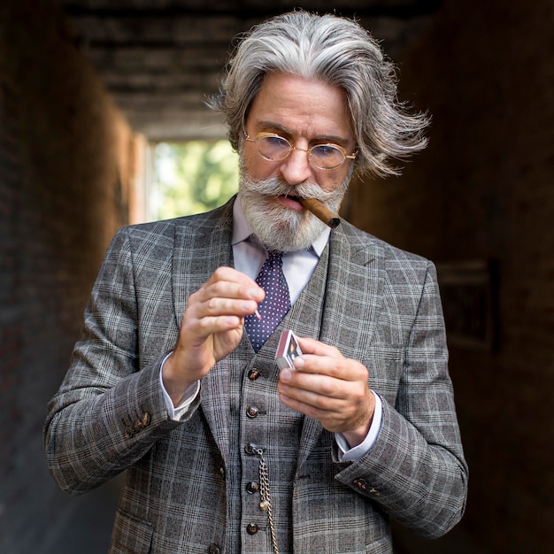 Portrait of bearded male lightning cigar