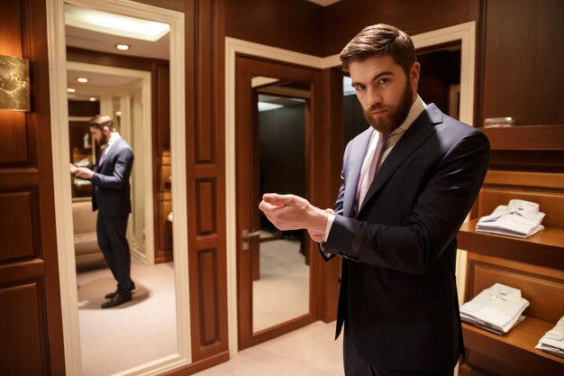 Portrait of bearded man in wardrobe