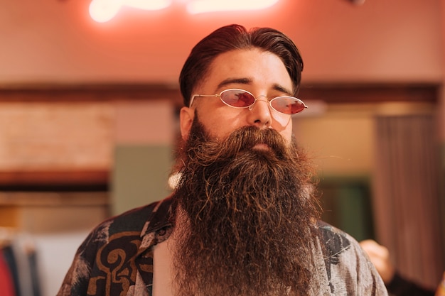 Portrait of a bearded man wearing sunglasses in the store