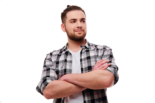 Portrait of a bearded, smiling male with crossed arms isolated on white background.