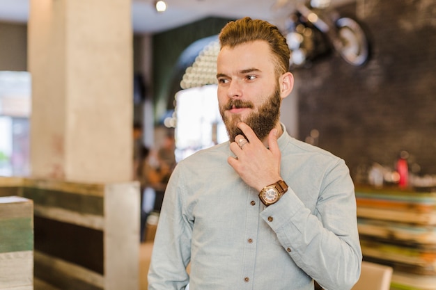 Portrait of a bearded young man looking away