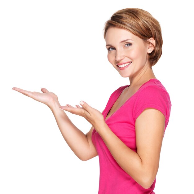 Portrait of a beautiful adult happy woman with presentation gesture over white space