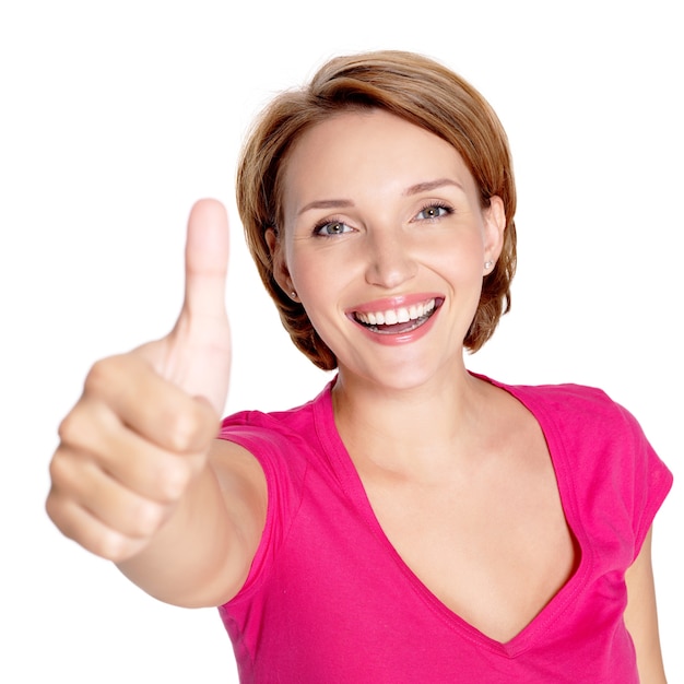 Free photo portrait of a beautiful adult happy woman with thumbs up sign over white wall