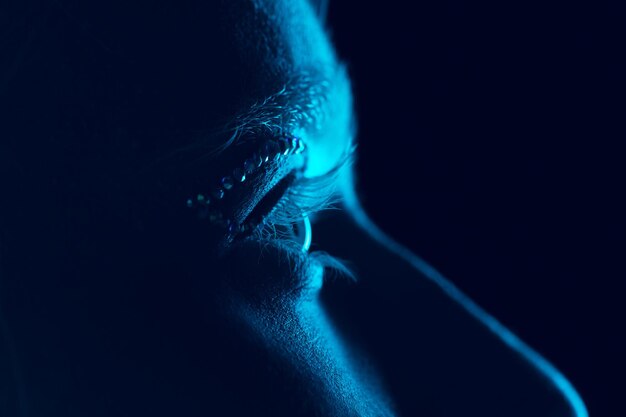 Portrait of beautiful albino girl isolated on dark studio in neon light