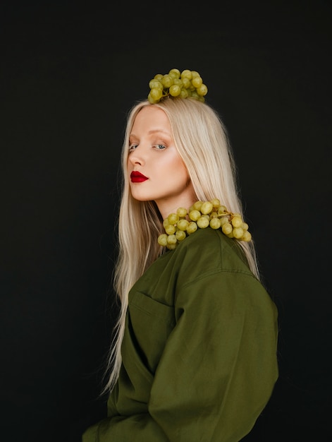 Portrait of beautiful albino woman with grapes