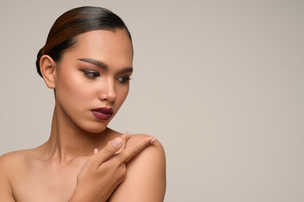 Portrait of beautiful asian woman touches on her shoulder