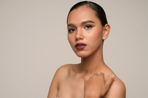 Portrait of beautiful asian woman touches on shoulder