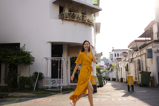 Portrait of beautiful asian woman using smartphone outdoors in the city