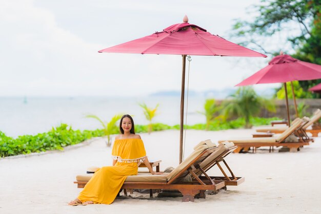 Portrait beautiful asian woman wear hat with smile happy leisure on the beach sea ocean in holiday vacation