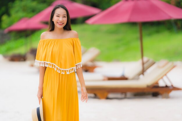 Portrait beautiful asian woman wear hat with smile happy leisure on the beach sea ocean in holiday vacation