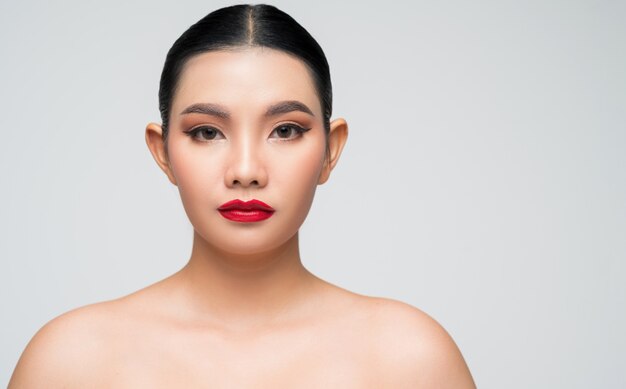 Portrait of beautiful asian woman with black hair and pink lips