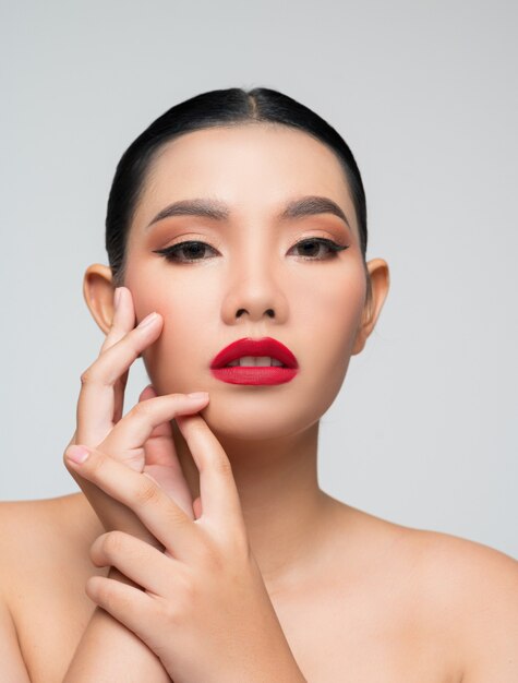 Portrait of beautiful asian woman with black hair and red lips