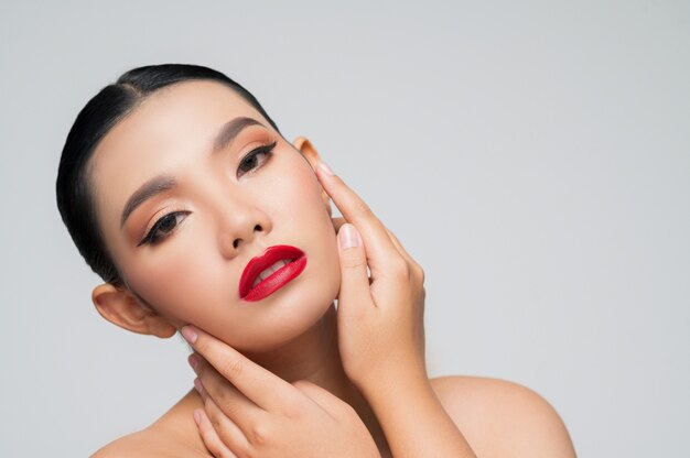 Portrait of beautiful asian woman with black hair and red lips