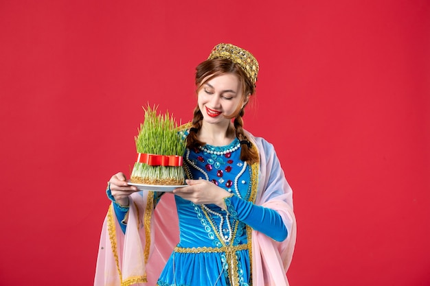 Free photo portrait of beautiful azeri woman in traditional dress with semeni on red