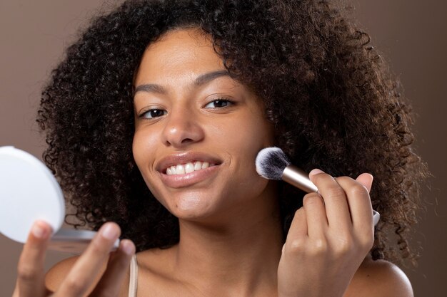 Portrait of beautiful black woman doing her skin care routine