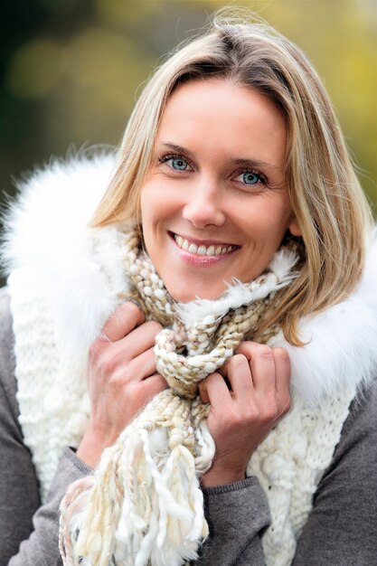 Portrait of beautiful blond woman in cold in autumn