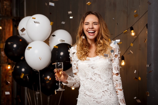 Portrait of beautiful blonde girl resting at party.