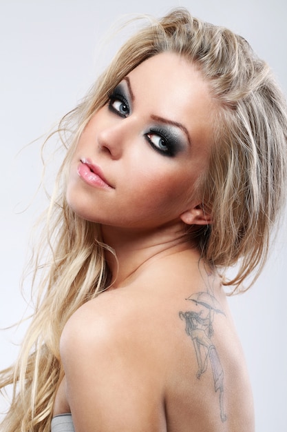 Portrait of beautiful blonde woman with dark makeup