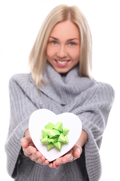 Portrait of beautiful blonde woman with heart-shaped gift box
