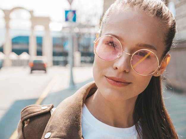 Portrait of beautiful brunette model dressed in summer hipster jacket clothes     