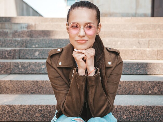 Portrait of beautiful brunette model dressed in summer hipster jacket clothes. 