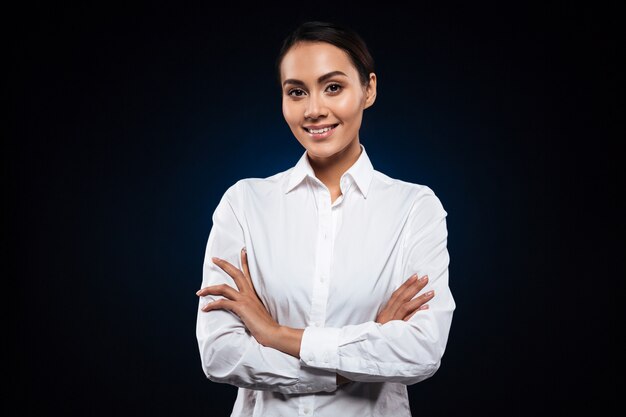 Portrait of beautiful brunette nurse isolated over black