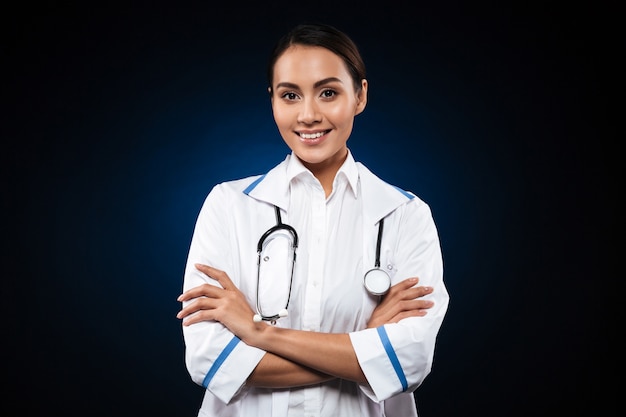 Portrait of beautiful brunette nurse isolated over black