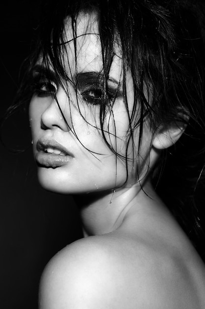 Portrait of beautiful brunette young woman with wet skin and hair