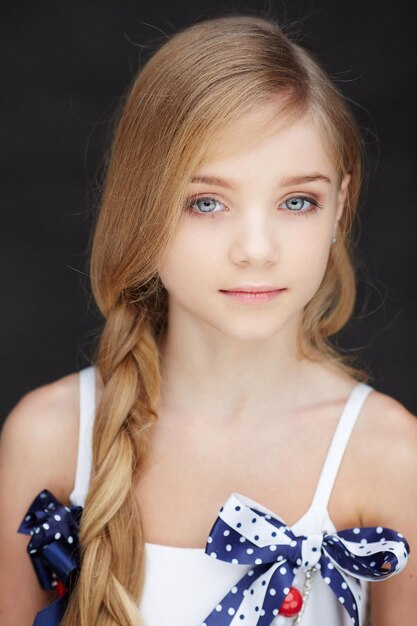 Portrait of beautiful child girl model with blue eyes.