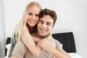 Free photo portrait of beautiful couple looking in bed