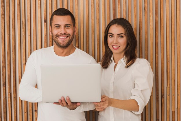 Portrait of beautiful couple with a laptop