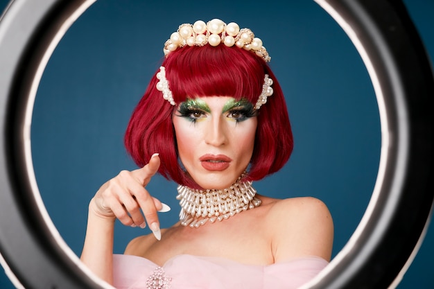 Portrait of beautiful drag person wearing makeup and wig