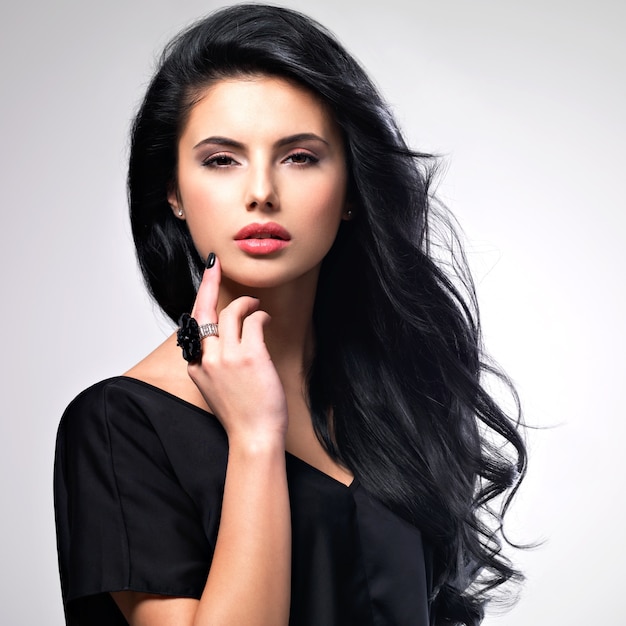 Portrait of beautiful face of an young woman with long brown hair.