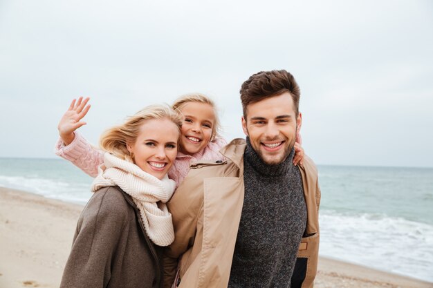 Portrait of a beautiful family with a little daughter having fun