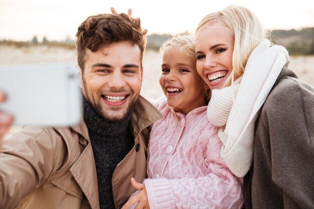 Portrait of a beautiful family with a little daughter