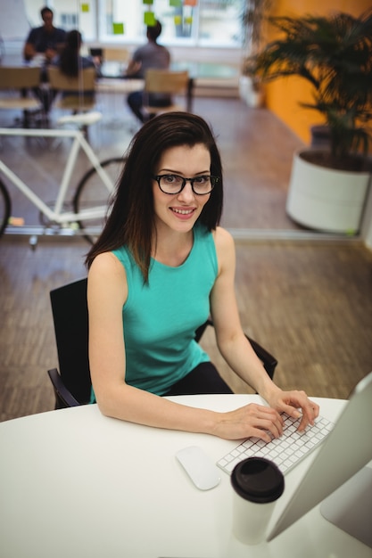 Portrait of beautiful female executive sitting at her desk