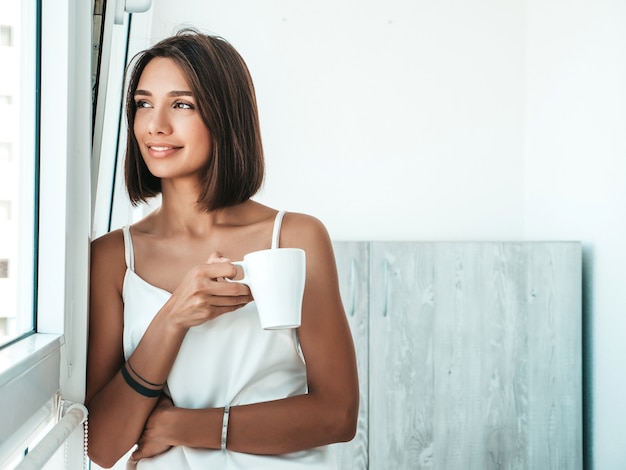 Portrait of beautiful girl dressed in white pajamas