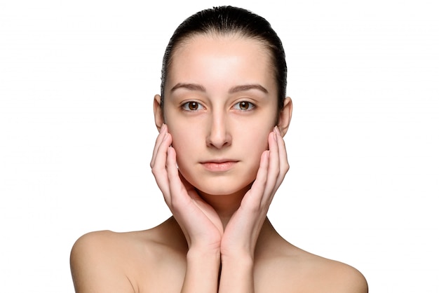 Portrait of beautiful girl stroking her face with healthy skin