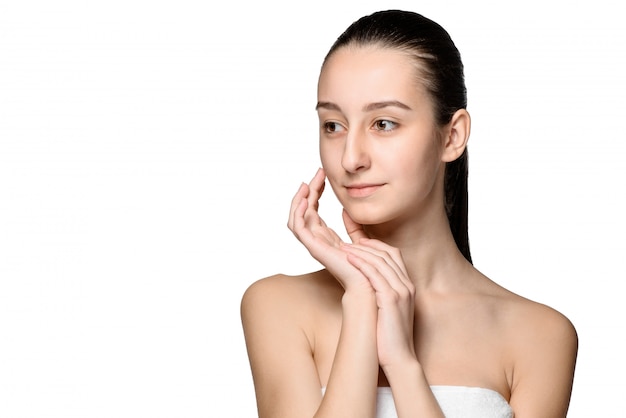 Portrait of beautiful girl stroking her face with healthy skin