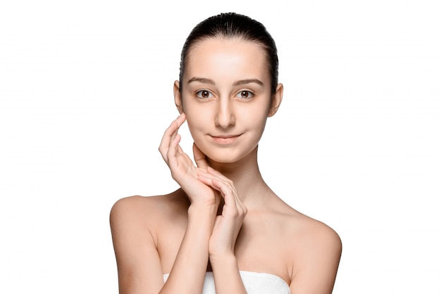 Portrait of beautiful girl stroking her face with healthy skin