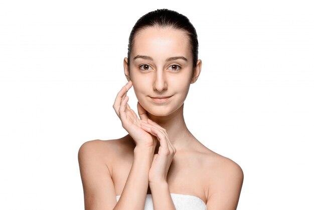 Portrait of beautiful girl stroking her face with healthy skin