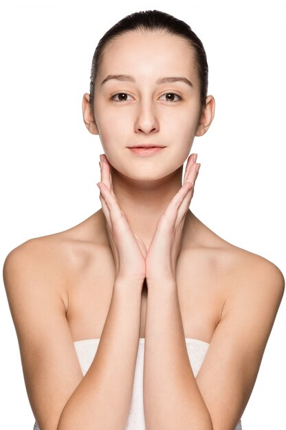 Portrait of beautiful girl stroking her face with healthy skin