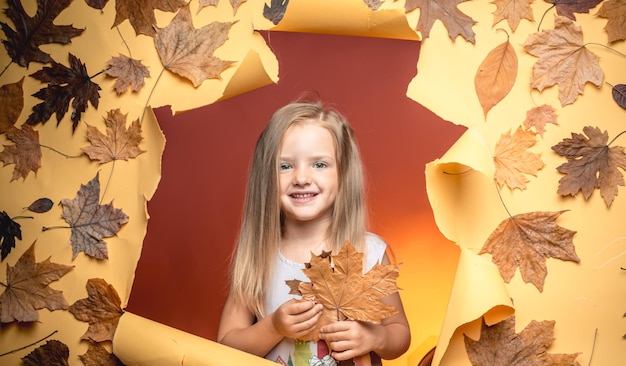 Portrait of a beautiful happy little boy close-up. happy children. autumn is a beautiful and colourful time of year. colorful autumn and dry autumn leaf. autumn design. space for your text.