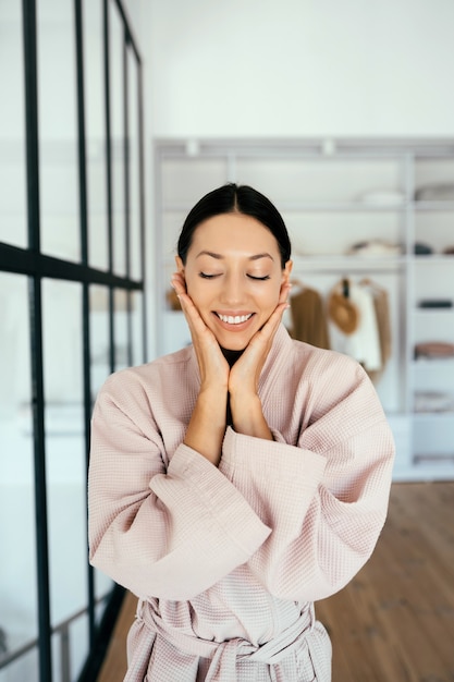 Free Photo portrait of a beautiful healthy woman in bathrobe indoors