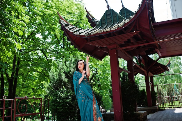 Portrait of beautiful indian brumette girl or hindu woman model against japanese traditional house